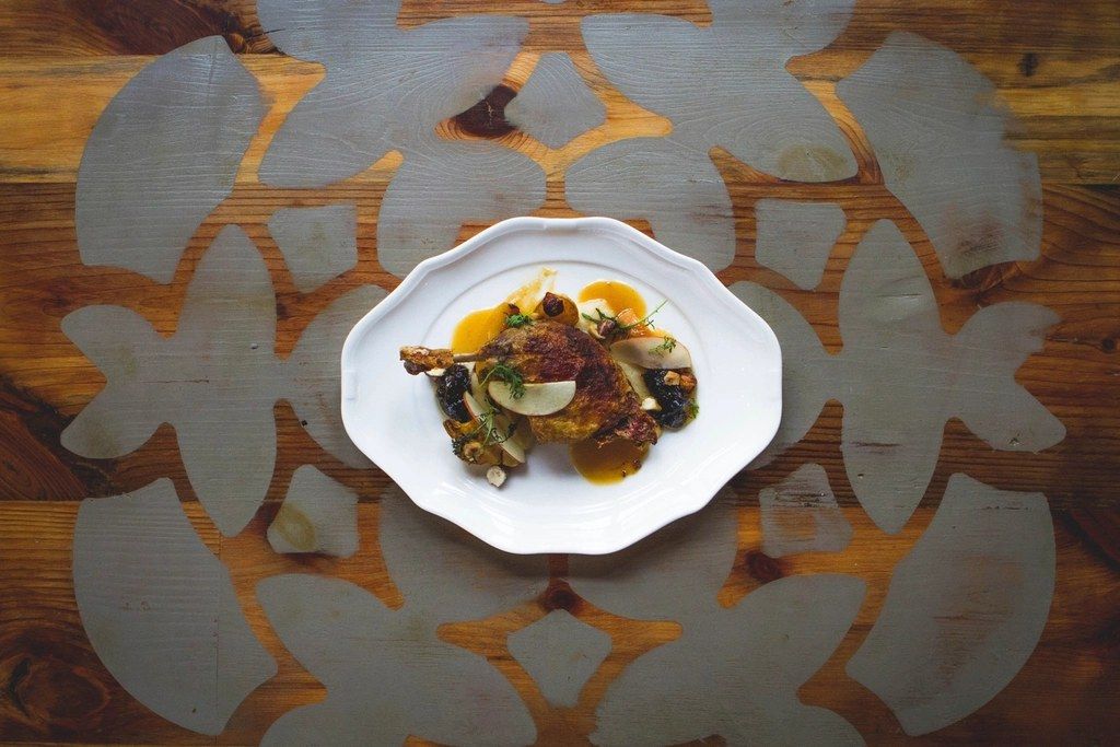 A plated dish photographed from above on a worn wooden table